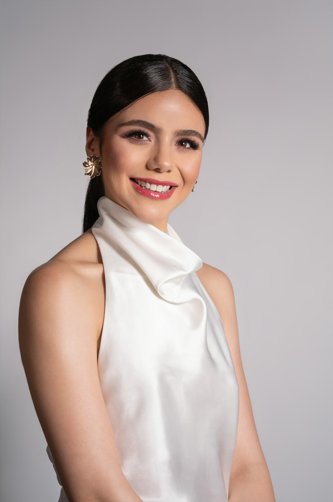 Studio portrait of a smiling professional woman with dark hair
