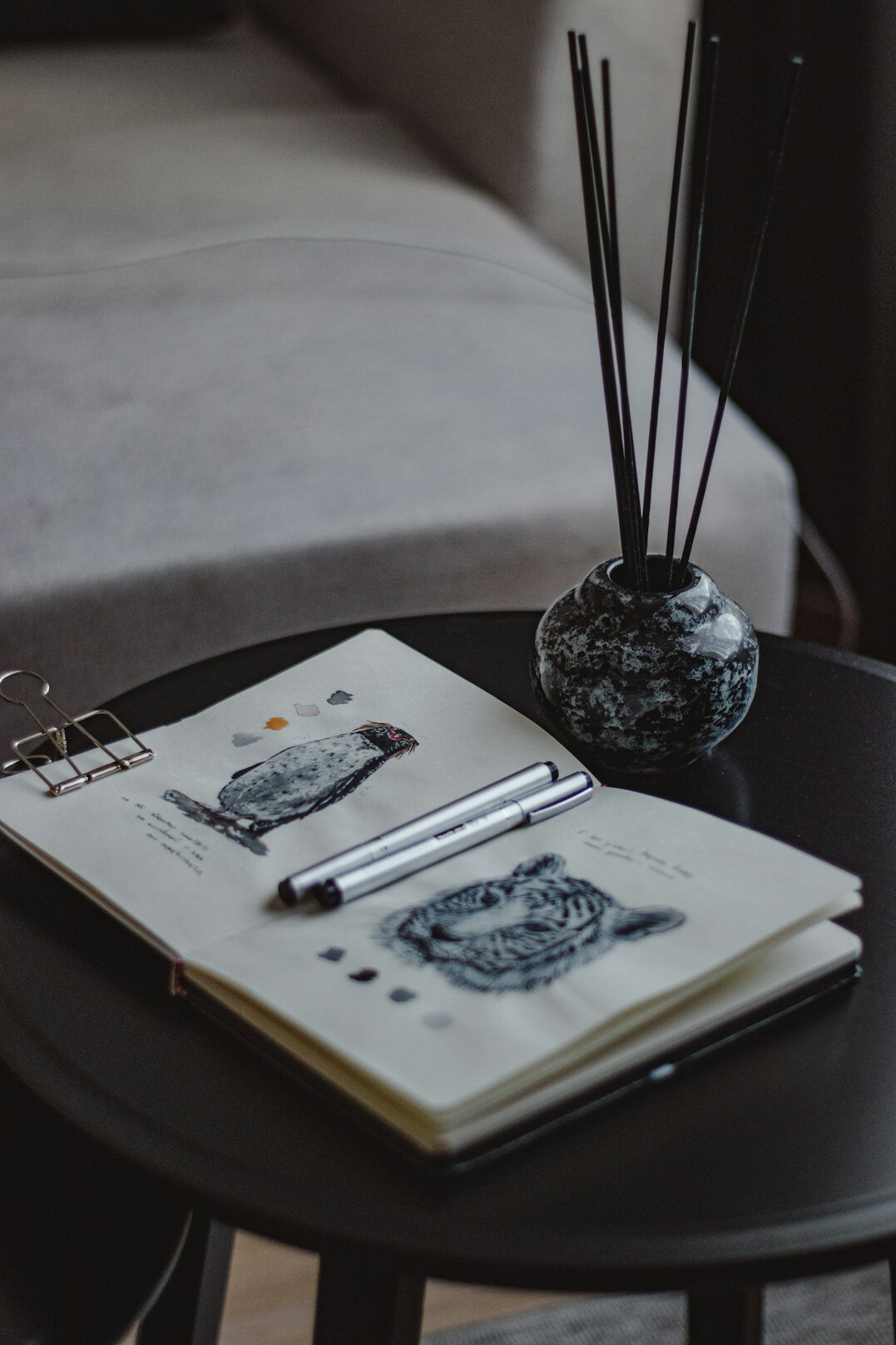 Pen writing in a notebook on a desk