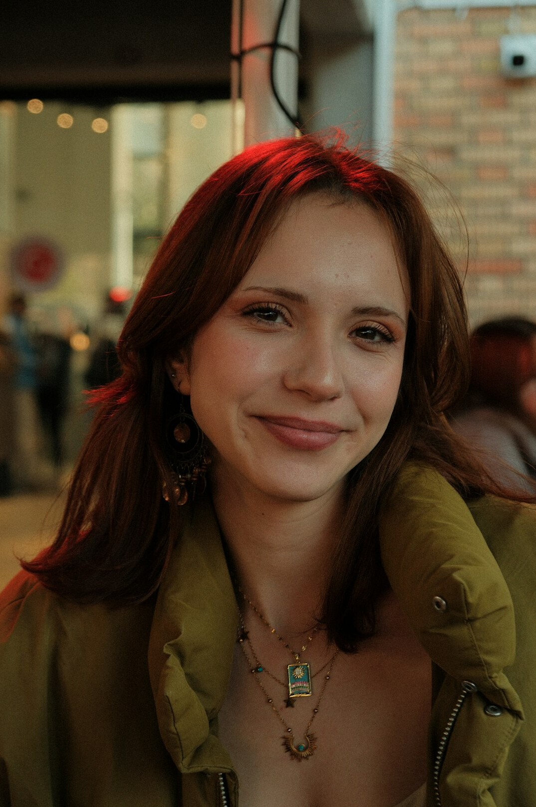 Portrait of a young woman with light brown hair smiling