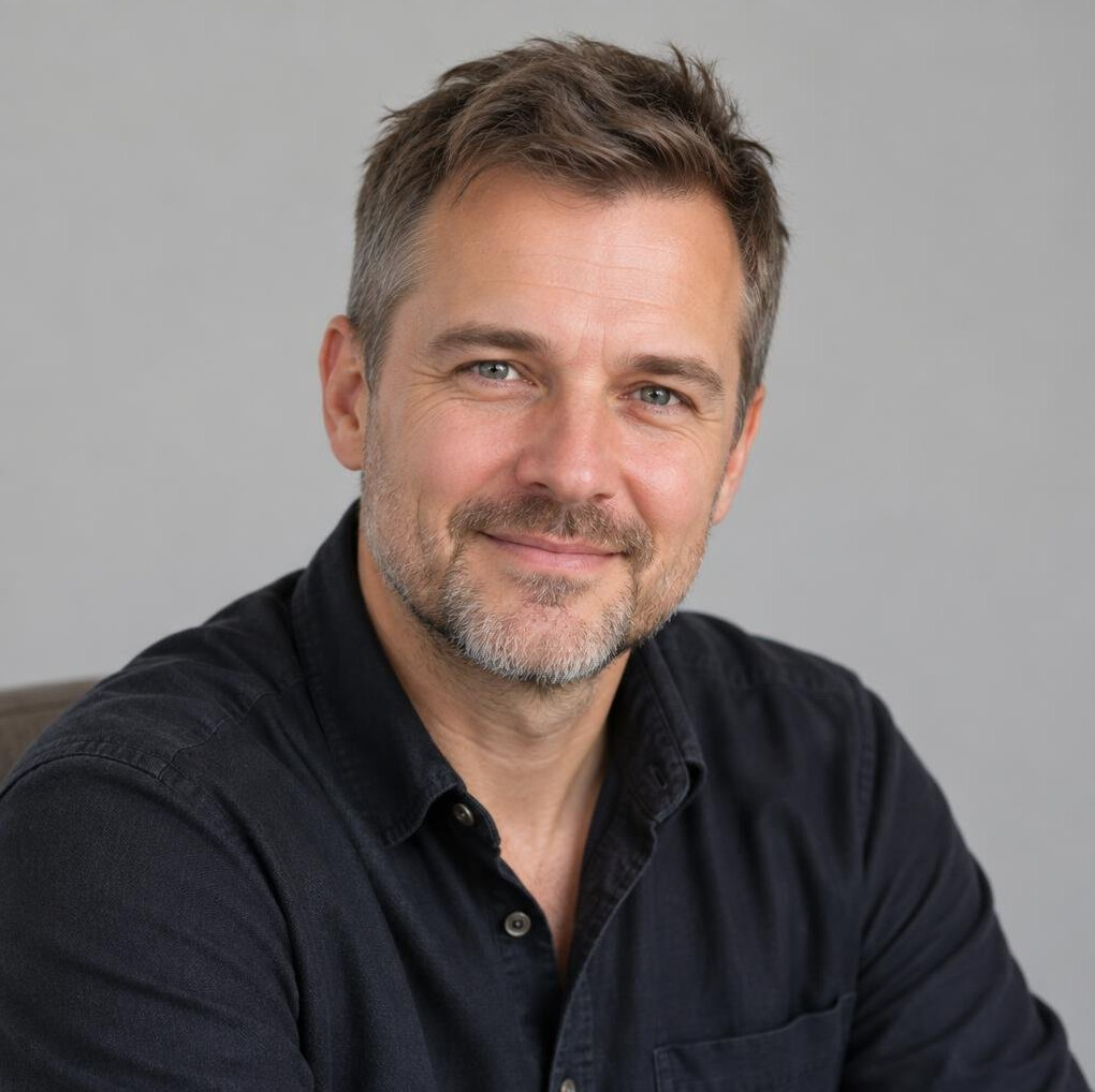 Portrait of a man with a light beard in a casual shirt